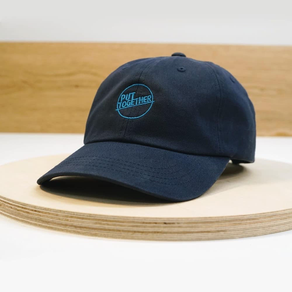 June 17th, 2021: Presenting our Put Together baseball cap! These hats will be available on our store in very limited supply tomorrow (6/18)! Featuring a high quality, embroidered Put Together logo and easily adjustable strap to fit anyone, our navy blue caps will be a perfect addition to any summer fit!